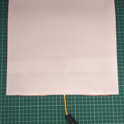 Putting a piece of paper onto the sensor. A single A4 wasn't big enough, so I've taped two pieces together. It's a bit hard to see, but I've taped the paper to the footpad on the bottom (aligning the bottom edge with the sensor), so that it won't move.