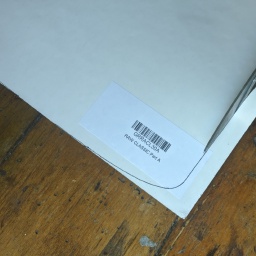 With the templated traced out on the back side of the grip tape, cutting the grip tape with beater scissors. Yes, they do get ruined quite fast...